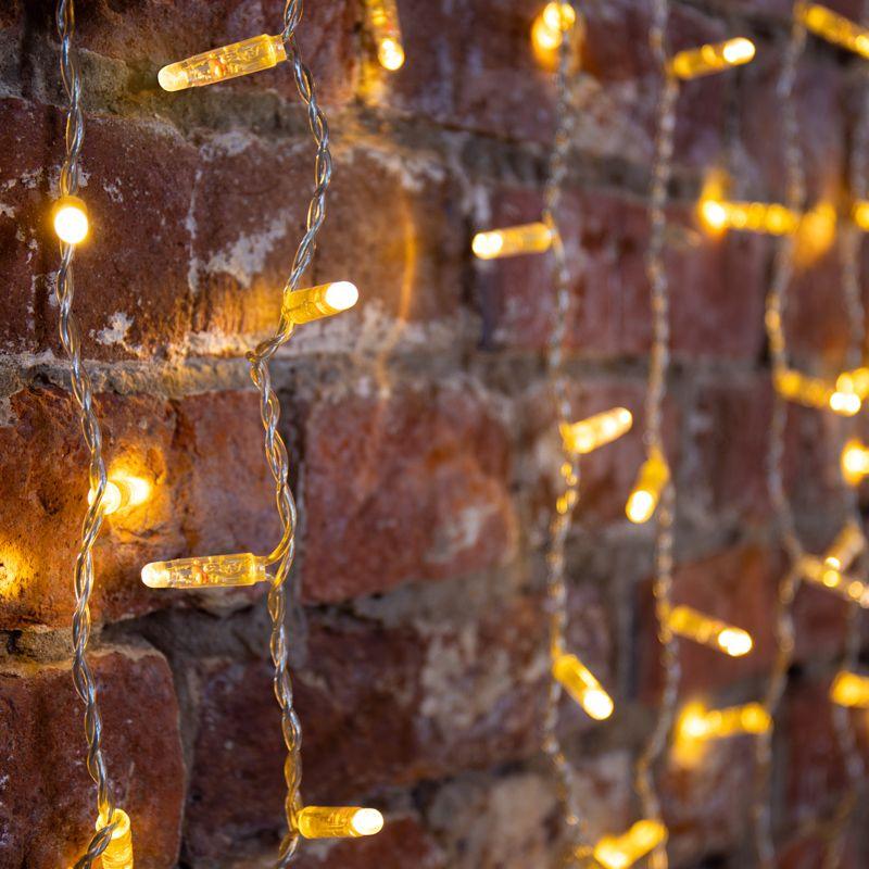 Гирлянда светодиодная "Светодиодный Дождь" 2х3м 600LED тепл. бел. 66Вт 230В IP65 постоян. свечение провод силикон. прозр. (нужен шнур питания 303-500-1) Neon-Night 235-156